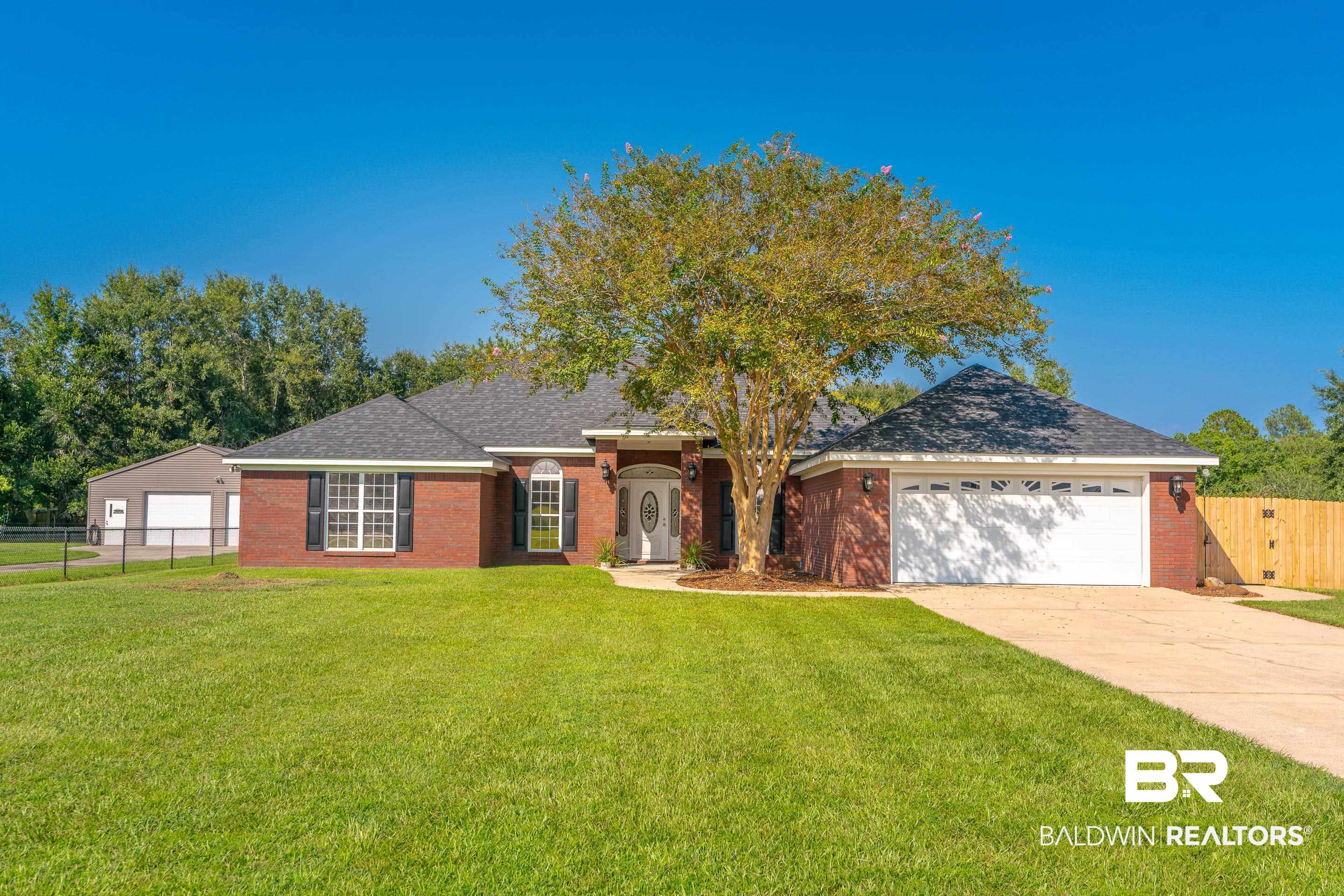 9477 Deerfield Drive Irvington, AL 36544 - Photo 1 of 58 Ranch-style home featuring a front lawn and a garage