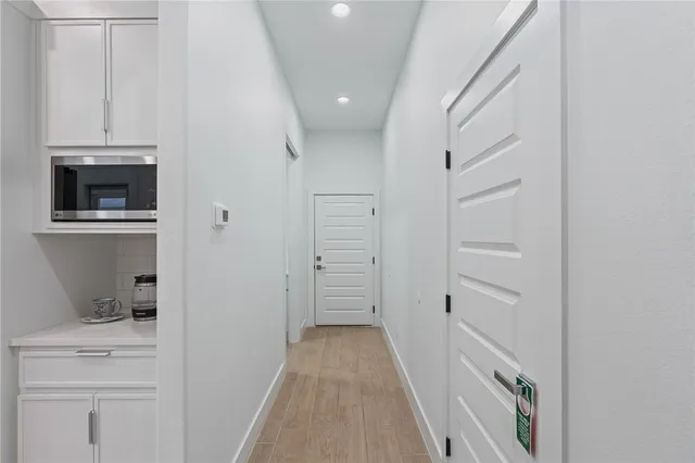 a kitchen with stainless steel appliances kitchen island granite countertop a stove a refrigerator and a dining table with wooden floor