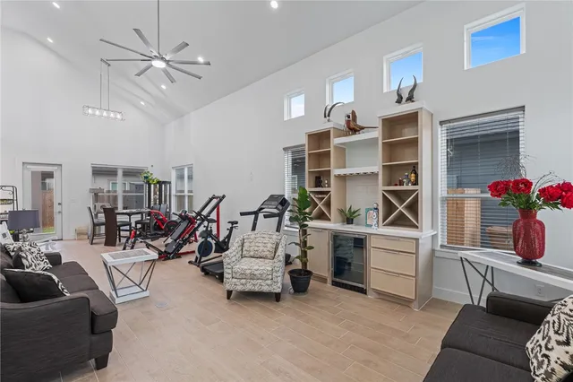 a living room with furniture gym equipment and white walls