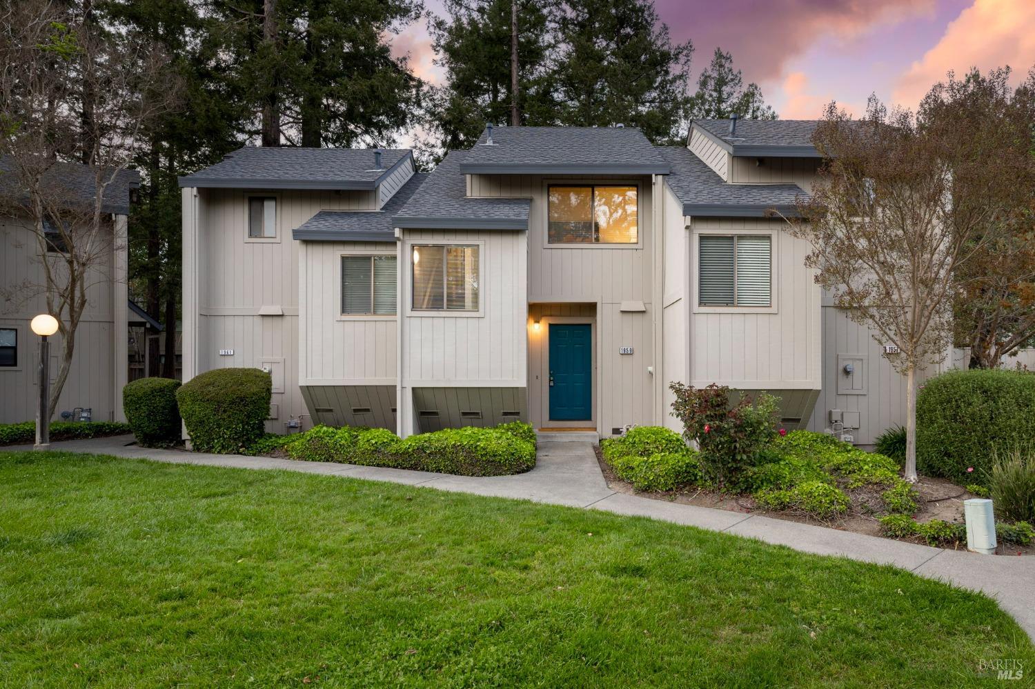 a front view of a house with a garden