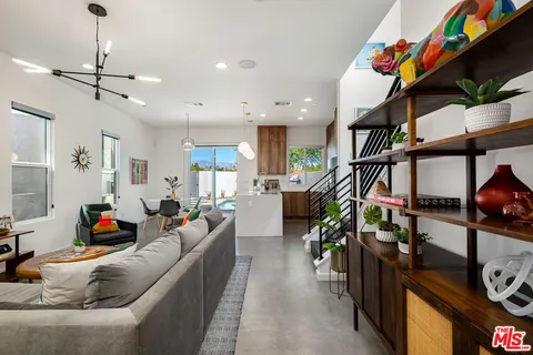 a bedroom with a bed and a potted plant