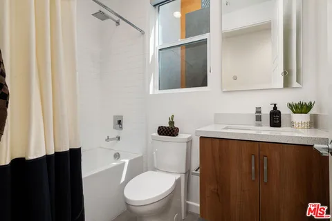 a bedroom with a bed and large window