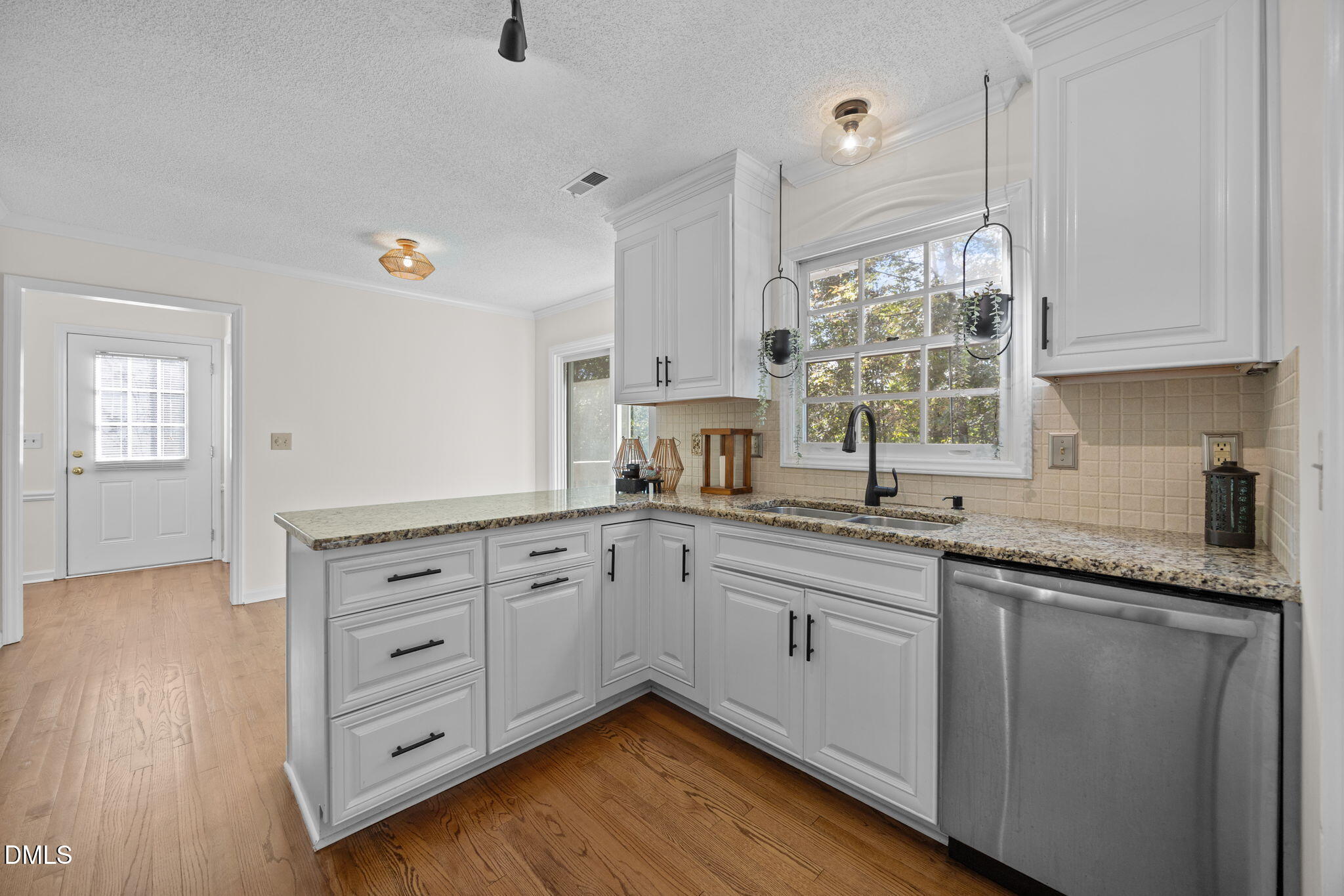 102 Korbel Place Cary, NC 27513 - Photo 12 of 43 a kitchen with granite countertop white cabinets and white appliances