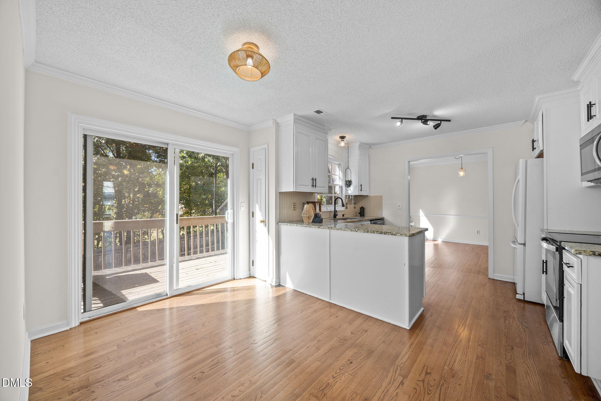 102 Korbel Place Cary, NC 27513 - Photo 16 of 43 a room with kitchen island wooden floor and window