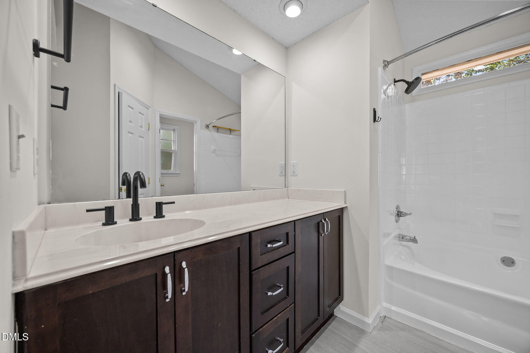 102 Korbel Place Cary, NC 27513 - Photo 22 of 43 a bathroom with a granite countertop sink a mirror a vanity and a bathtub