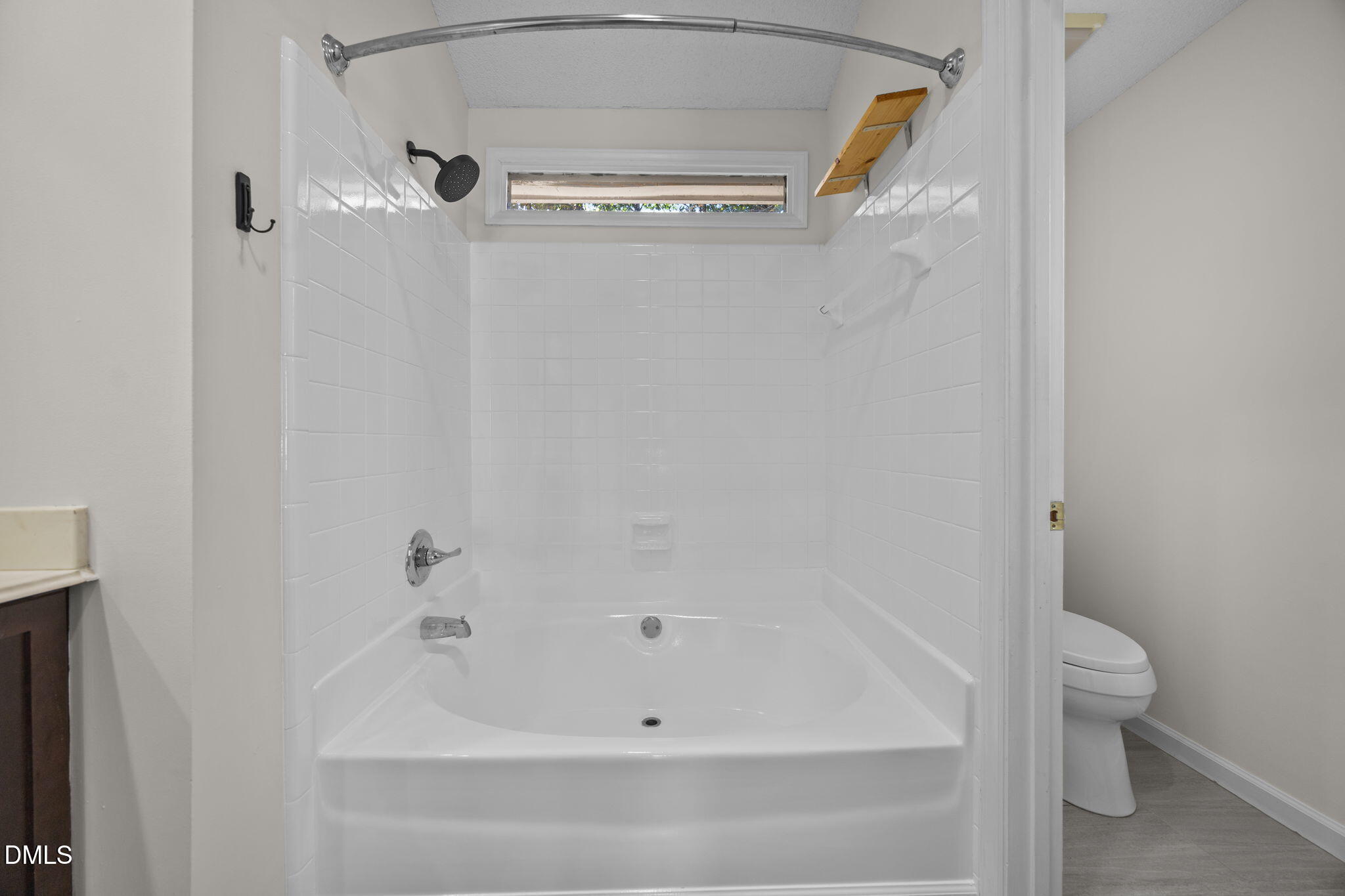 102 Korbel Place Cary, NC 27513 - Photo 23 of 43 a bathroom with a bathtub and a toilet