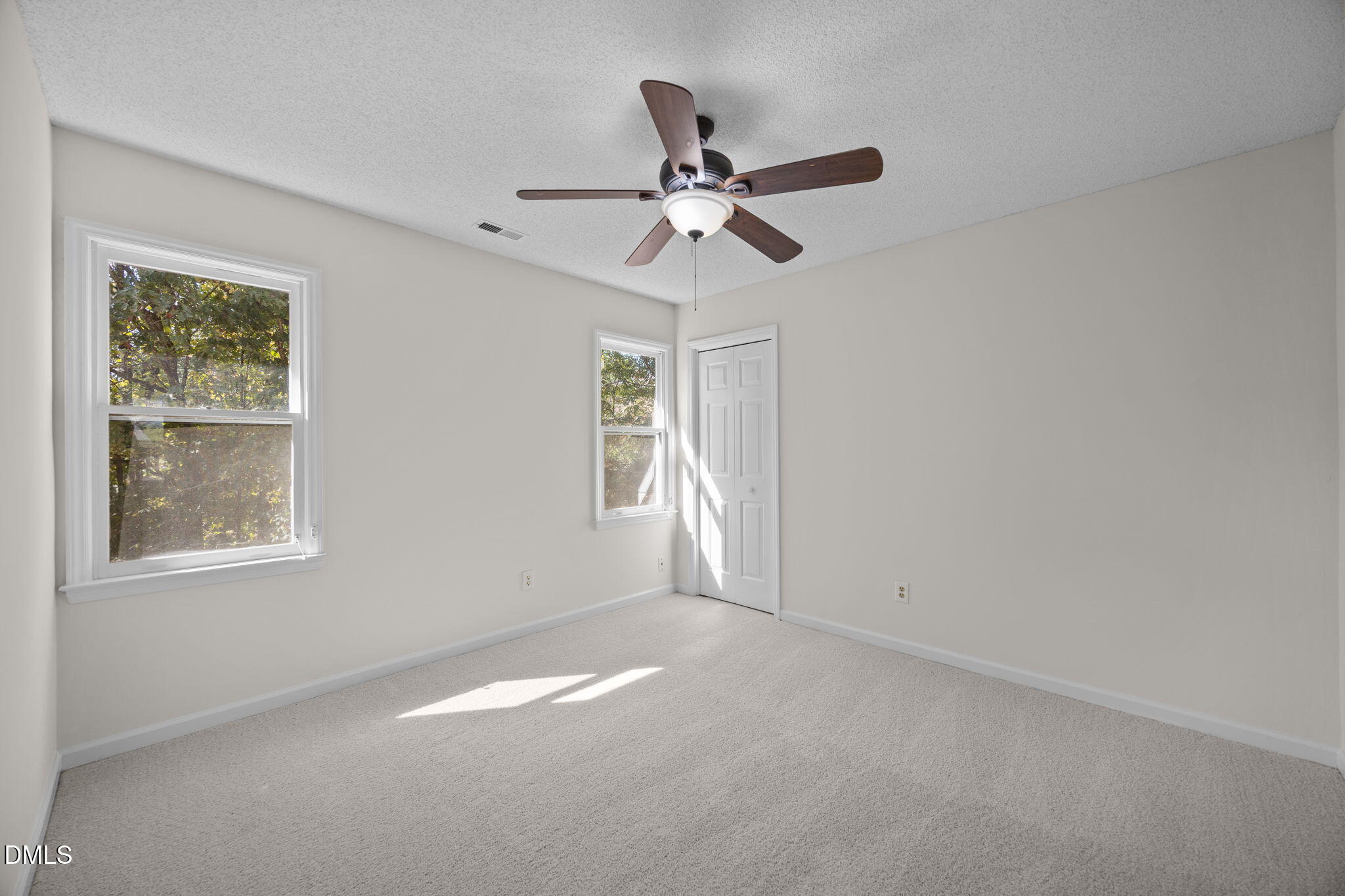 102 Korbel Place Cary, NC 27513 - Photo 28 of 43 an empty room with a window and a fan