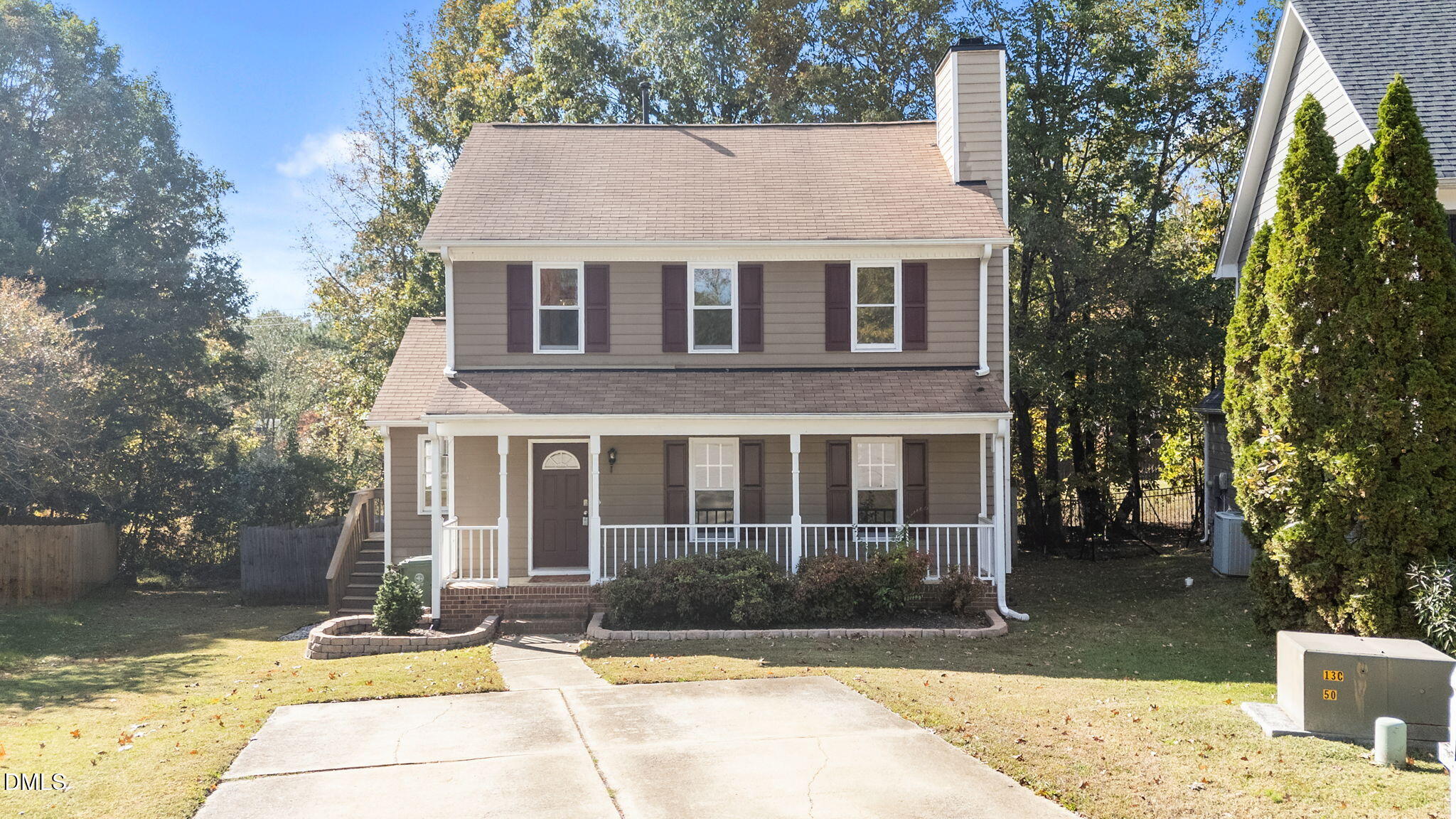 102 Korbel Place Cary, NC 27513 - Photo 39 of 43 a view of a white house with large windows and a tree