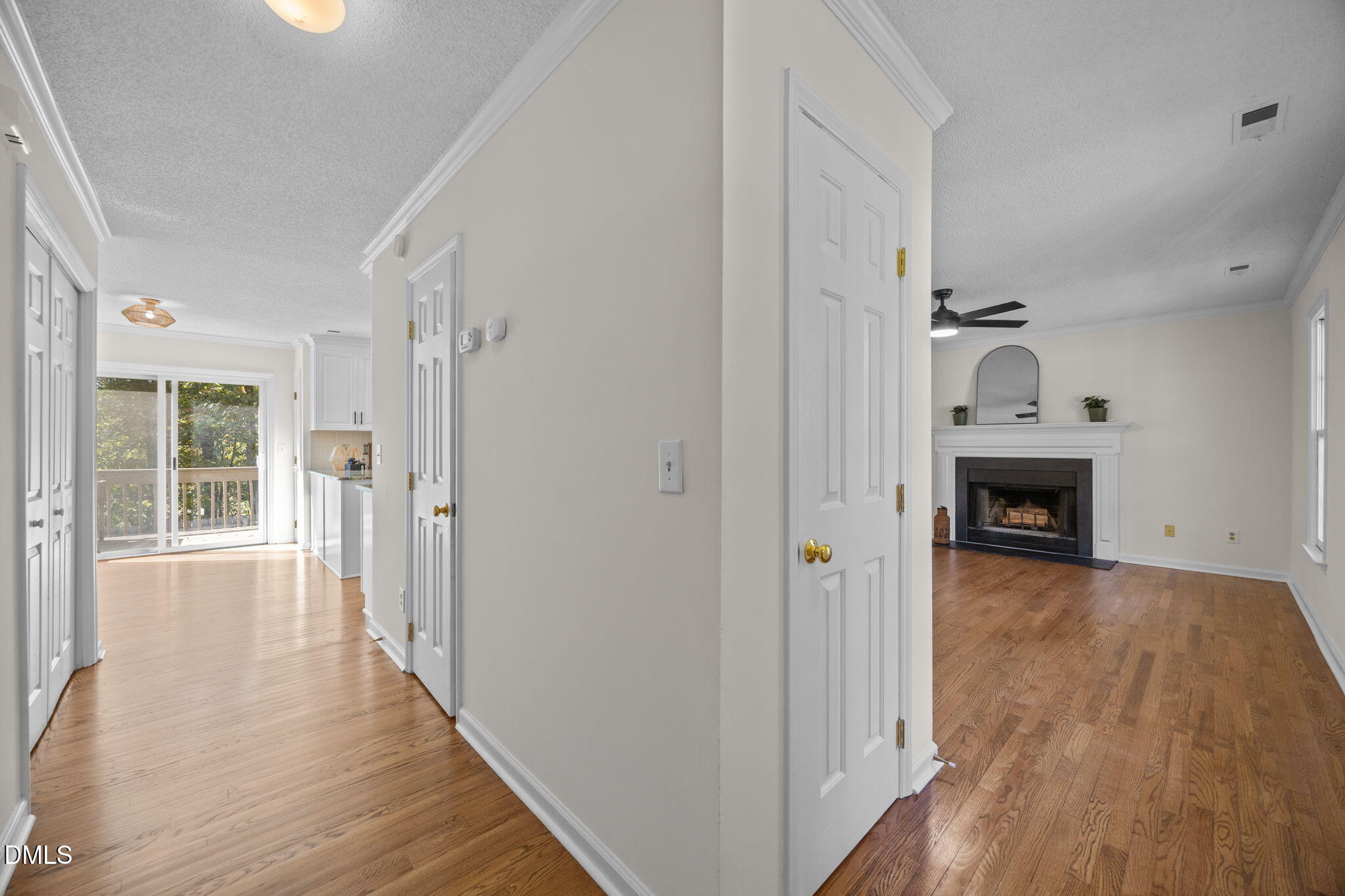 102 Korbel Place Cary, NC 27513 - Photo 6 of 43 a view of a hallway with wooden floor and a fireplace