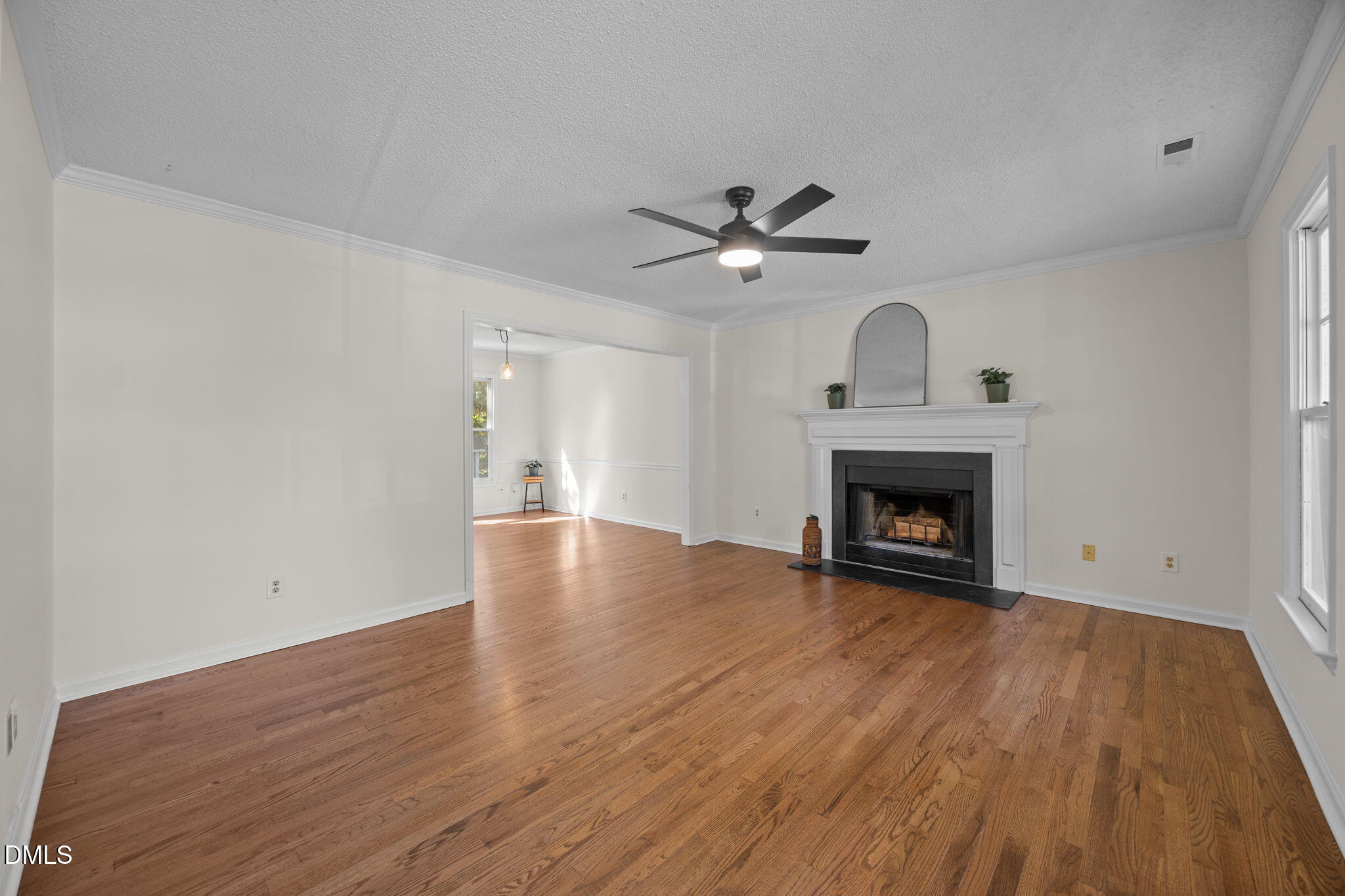 102 Korbel Place Cary, NC 27513 - Photo 7 of 43 a view of an empty room with wooden floor and a fireplace
