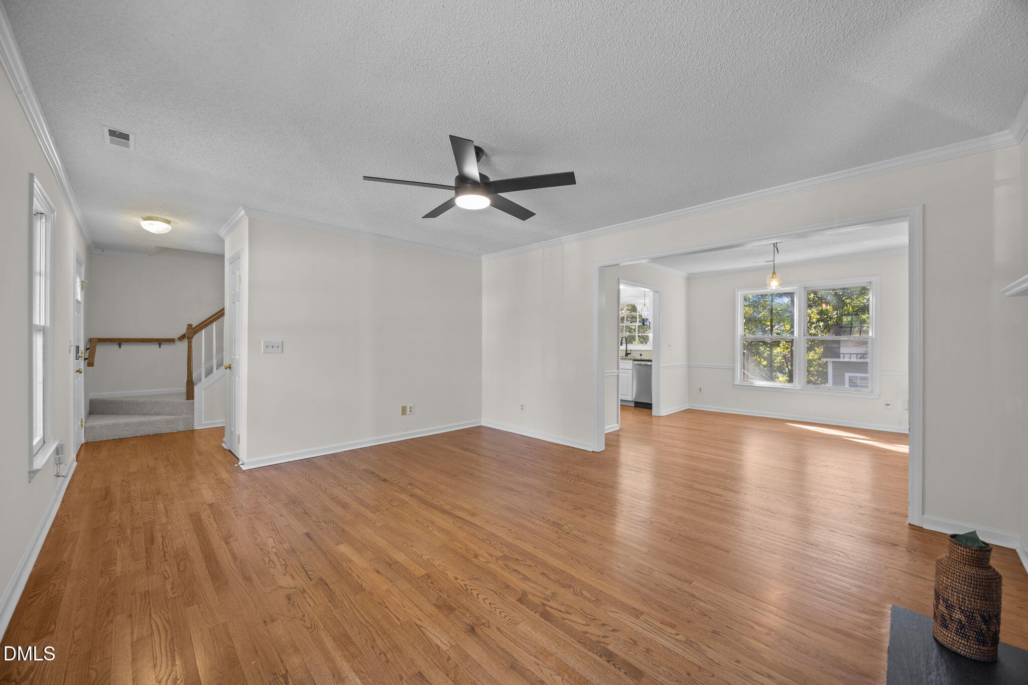102 Korbel Place Cary, NC 27513 - Photo 9 of 43 a view of an empty room with a window and wooden floor