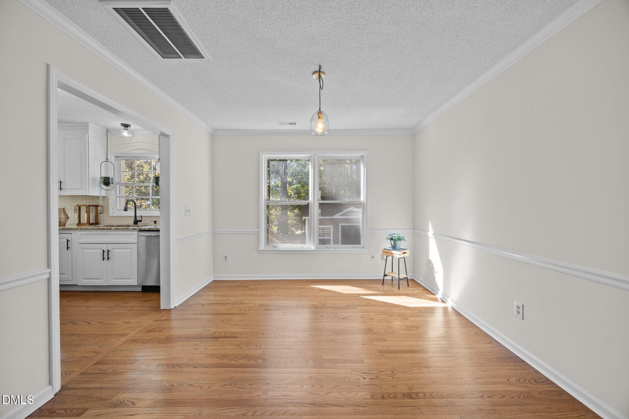 102 Korbel Place Cary, NC 27513 - Photo 10 of 43 a view of an empty room with a window and wooden floor