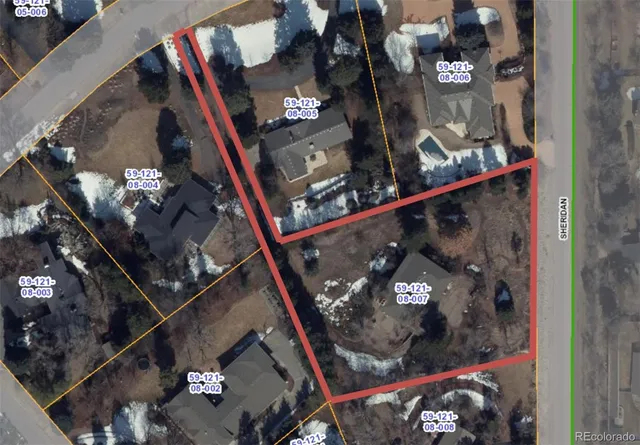 an aerial view of a house with a yard and large trees