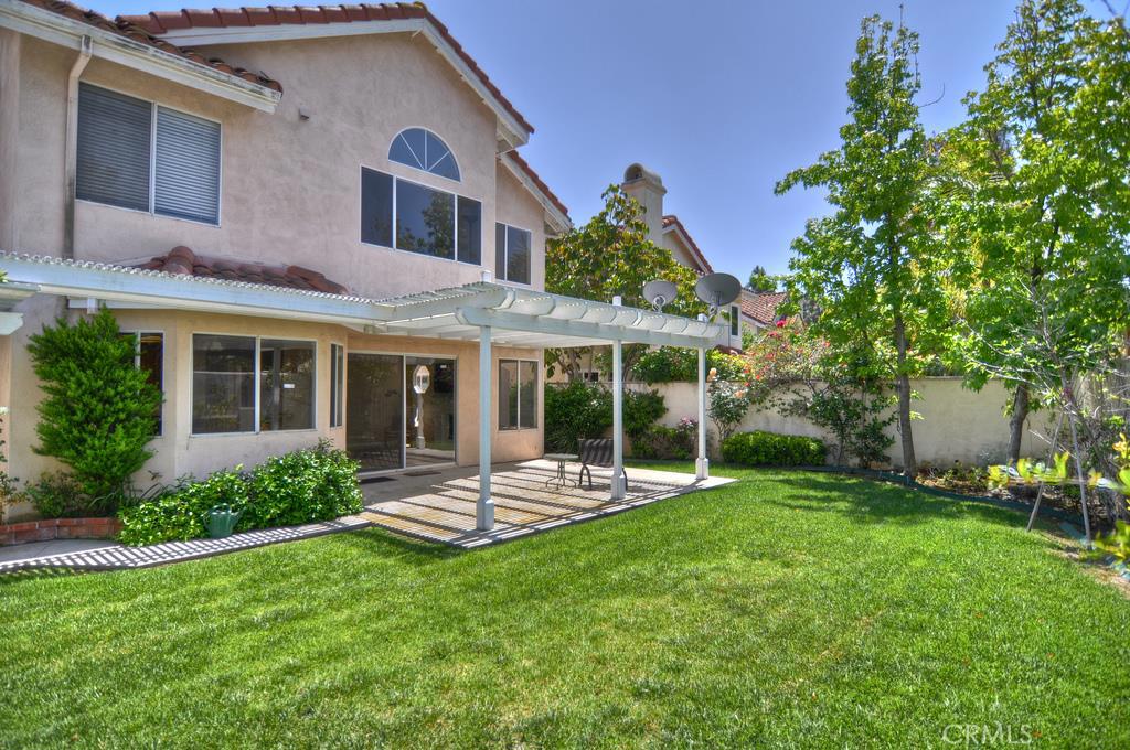9 Barcelona, Unit 1 Irvine, CA 92614 - Photo 11 of 11 a front view of a house with garden