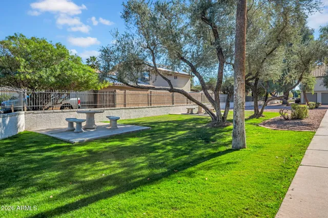 a house view with swimming pool and garden space