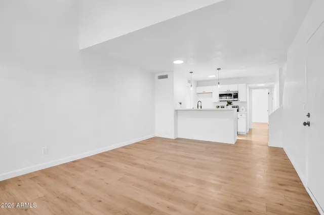 a view of a kitchen with a sink and a refrigerator