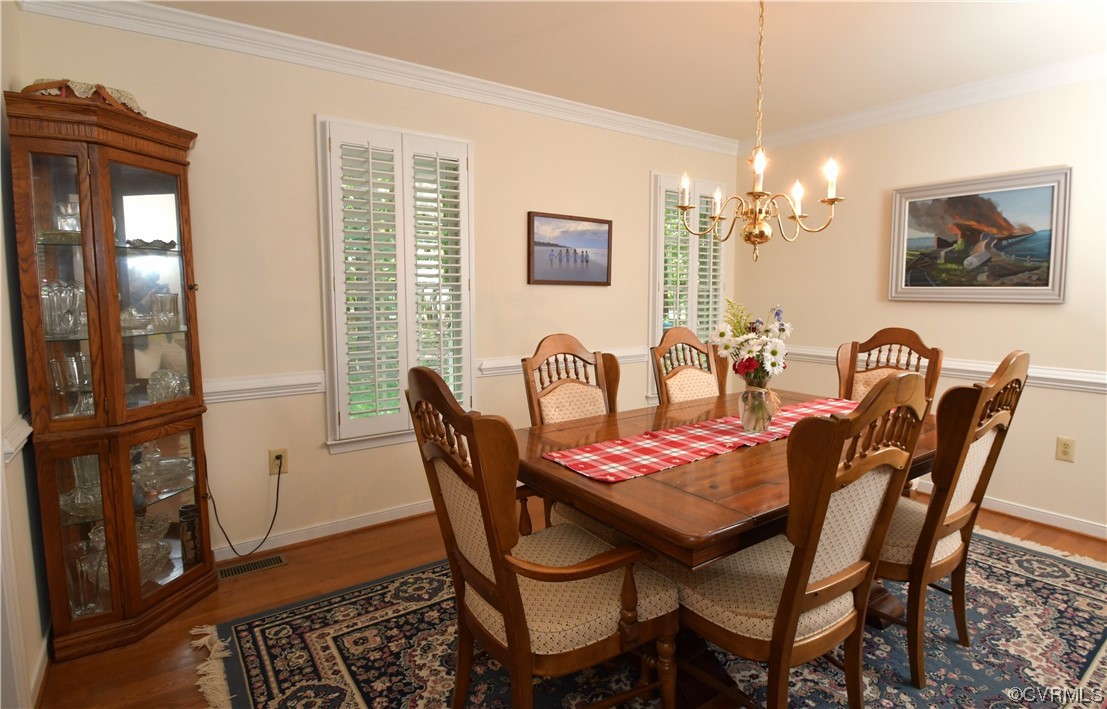 1438 Palmore Road Powhatan, VA 23139 - Photo 15 of 41 Formal dining room has hardwood floors, crown molding, chair railing and plantation shutters.