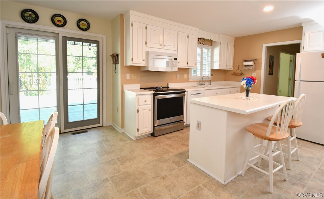 1438 Palmore Road Powhatan, VA 23139 - Photo 9 of 41 Kitchen with island and doors that lead out to deck.
