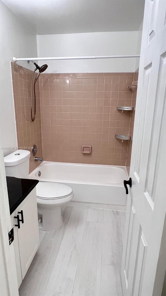 10669 Boca Entrada Boulevard Boca Raton, FL 33428 - Photo 10 of 19 a bathroom with a toilet a sink and shower