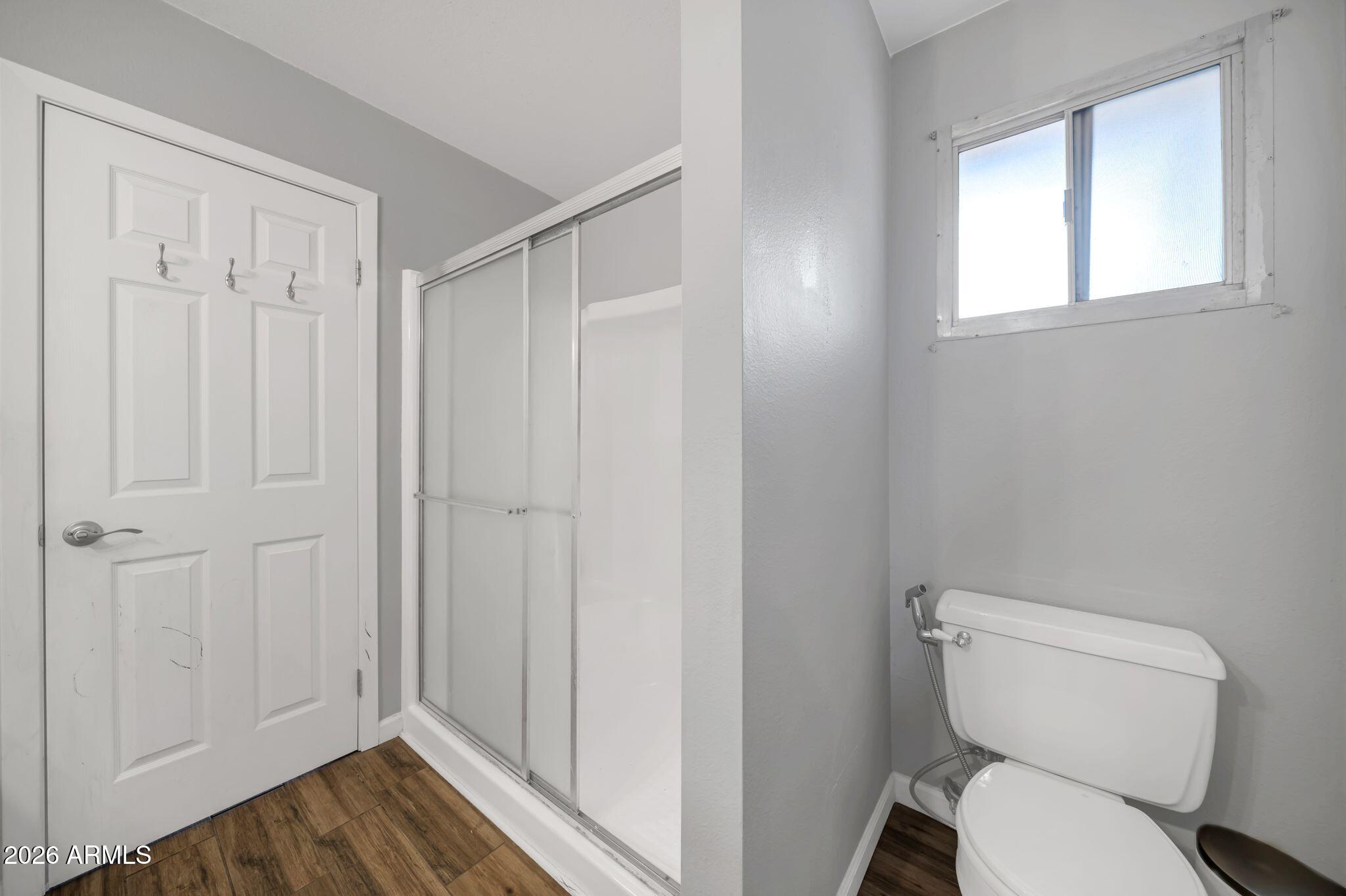 3041 West Acoma Drive Phoenix, AZ 85053 - Photo 14 of 35 a white toilet sitting next to a bathroom sink
