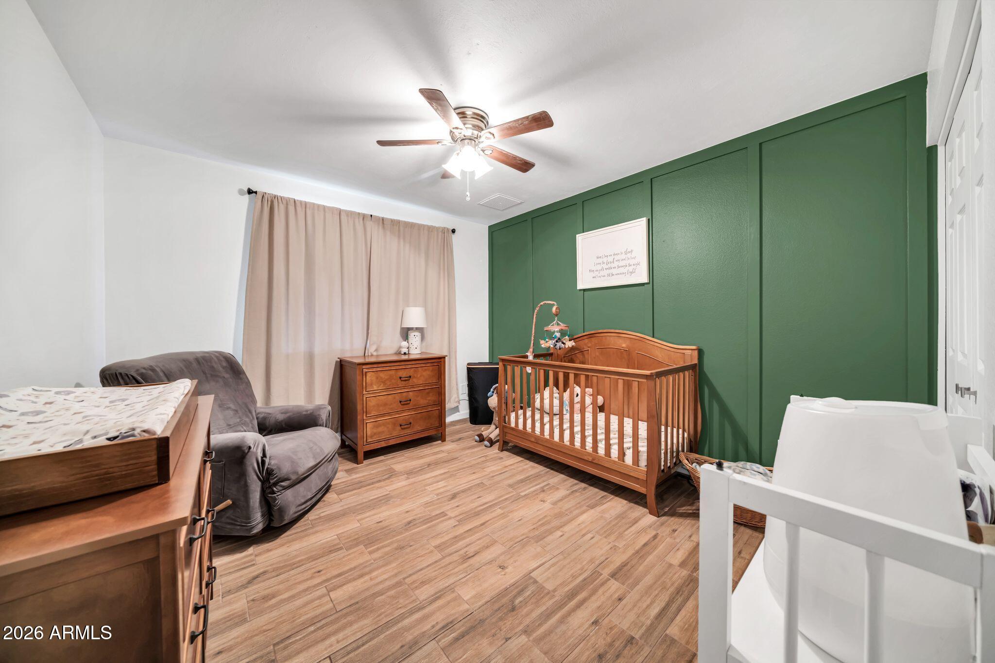 3041 West Acoma Drive Phoenix, AZ 85053 - Photo 16 of 35 a bedroom with a bed and a dresser