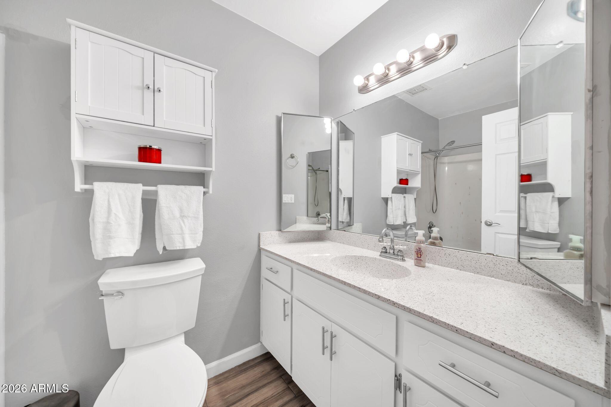 3041 West Acoma Drive Phoenix, AZ 85053 - Photo 19 of 35 a bathroom with a toilet sink and mirror