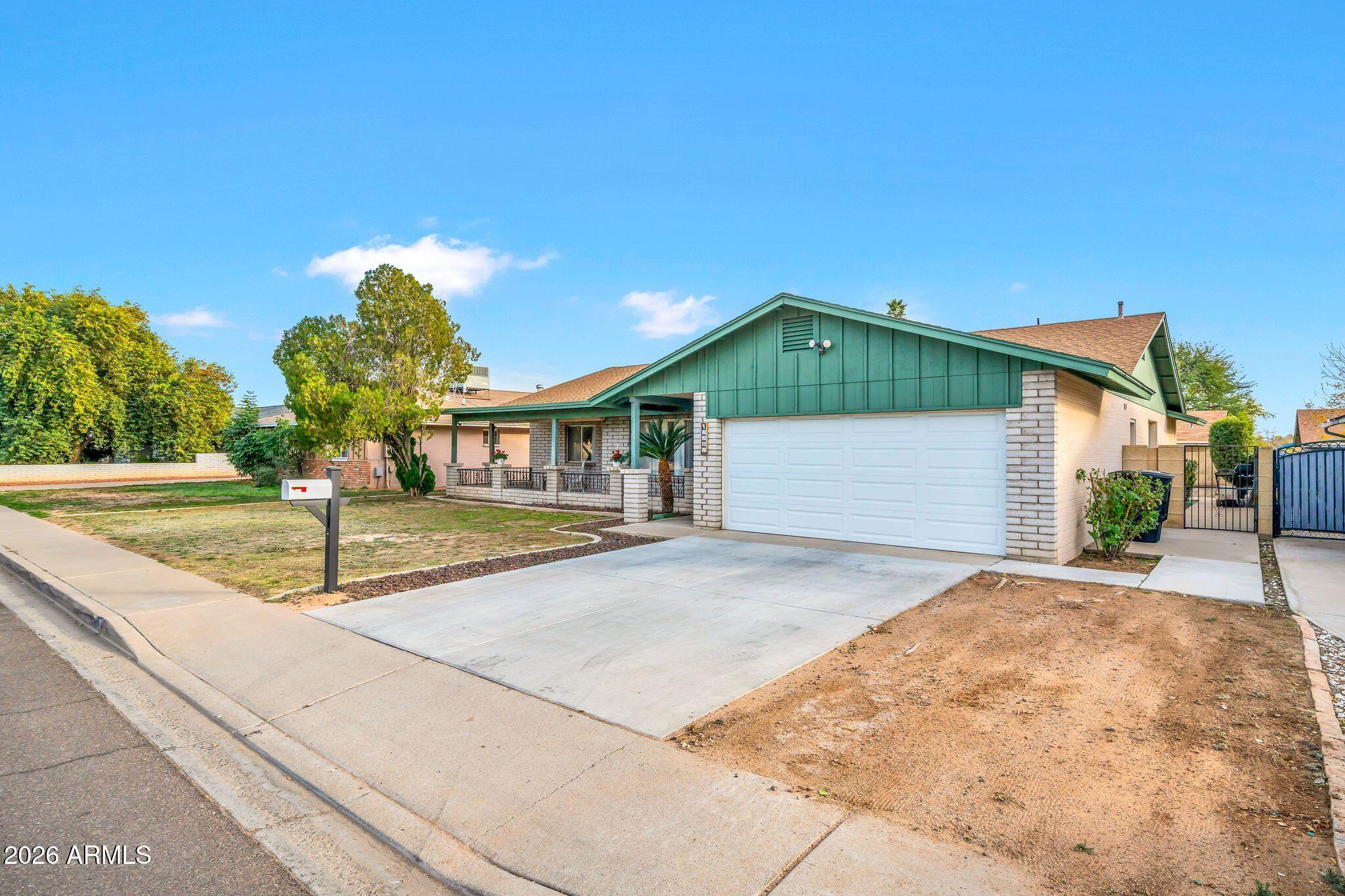 3041 West Acoma Drive Phoenix, AZ 85053 - Photo 22 of 35 a front view of a house with garden