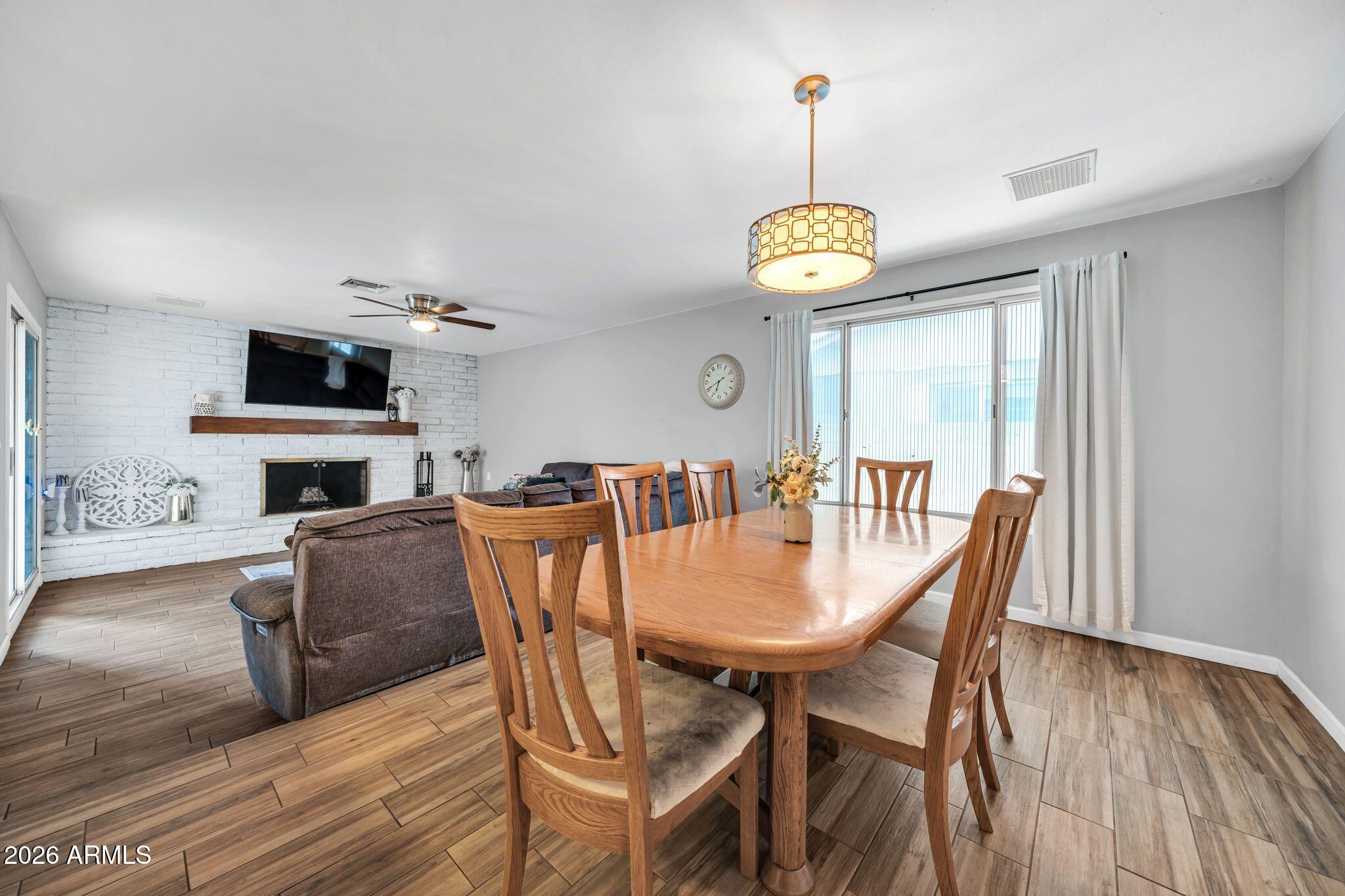 3041 West Acoma Drive Phoenix, AZ 85053 - Photo 29 of 35 a view of a dining room with furniture wooden floor and chandelier