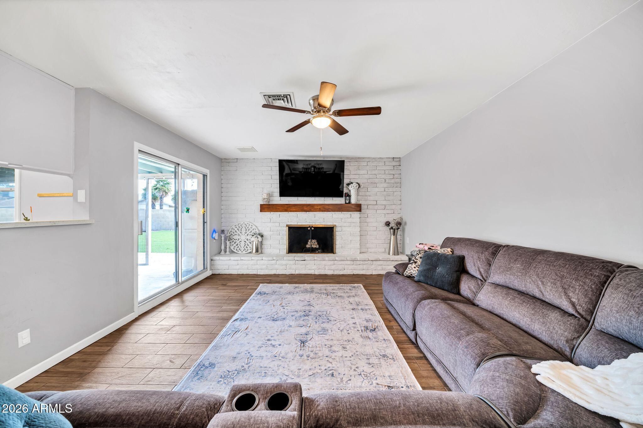 3041 West Acoma Drive Phoenix, AZ 85053 - Photo 30 of 35 a living room with furniture and a fireplace