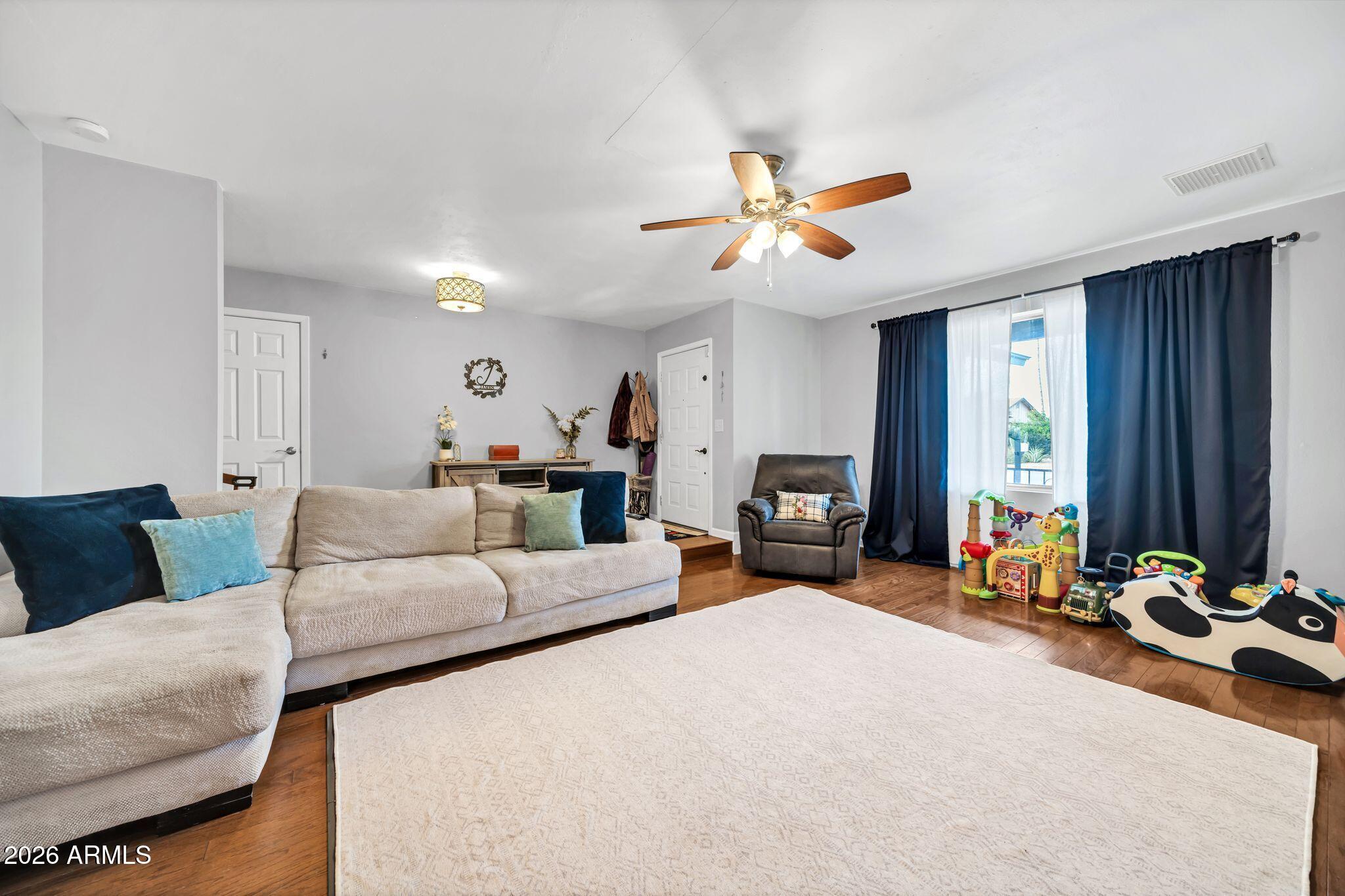 3041 West Acoma Drive Phoenix, AZ 85053 - Photo 34 of 35 a living room with furniture gym equipment and a large window