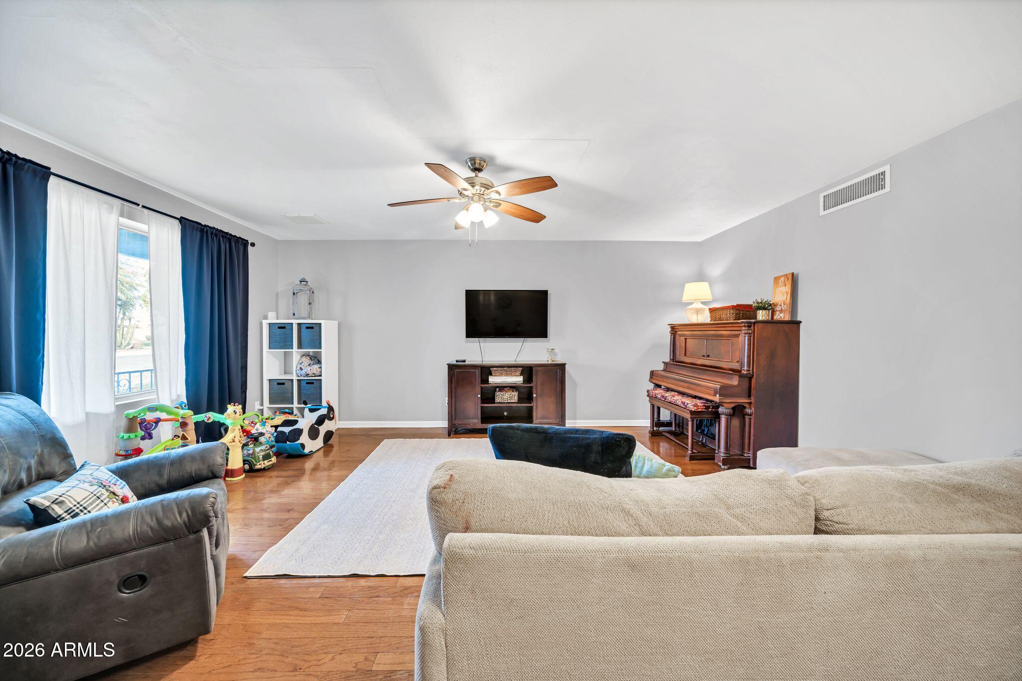 3041 West Acoma Drive Phoenix, AZ 85053 - Photo 6 of 35 a living room with furniture and a flat screen tv