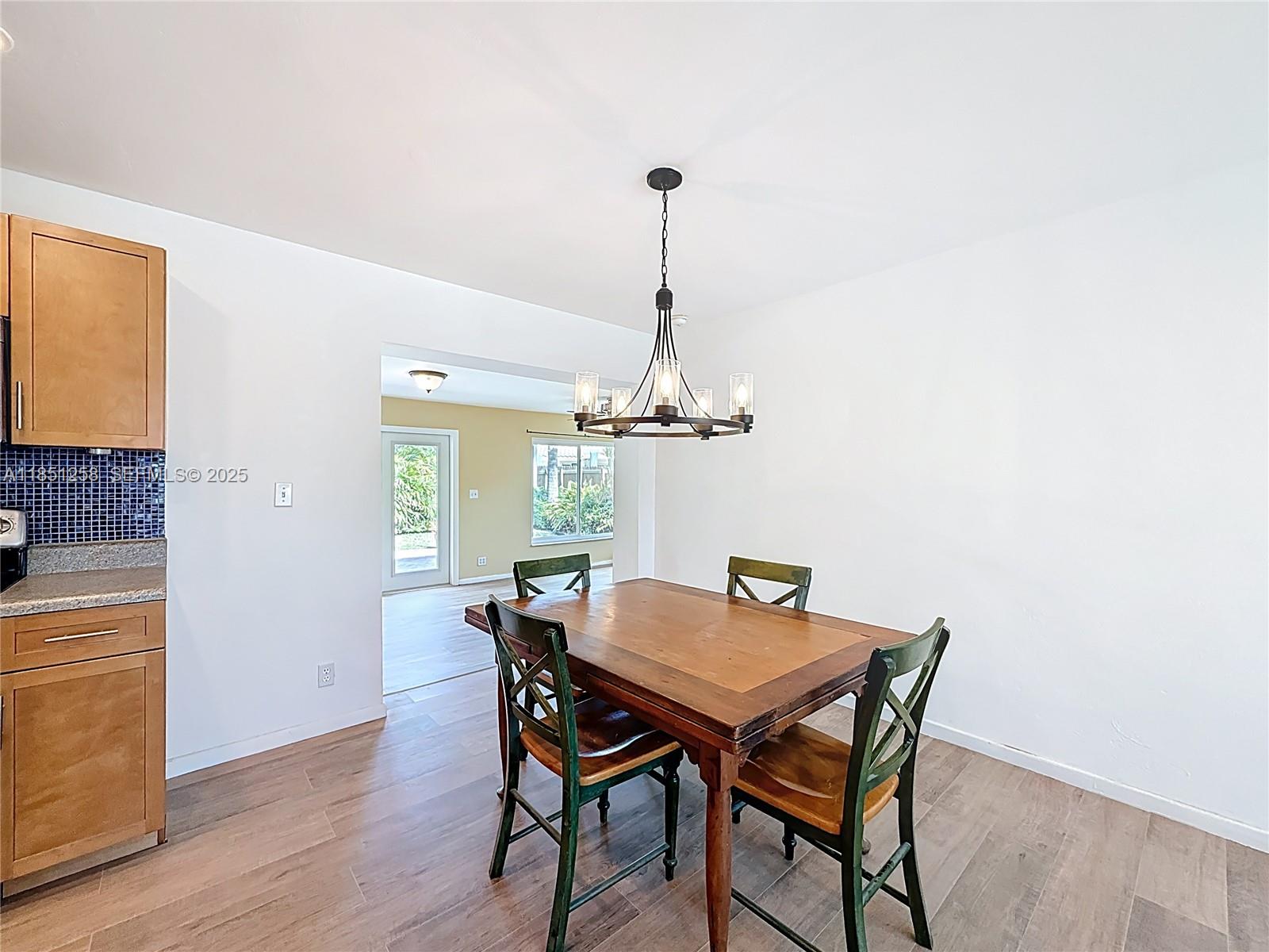 4911 Northeast 24th Avenue Lighthouse Point, FL 33064 - Photo 12 of 63 a view of a dining room with furniture window and wooden floor