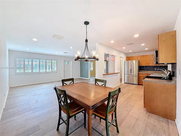 a view of a room with furniture and wooden floor