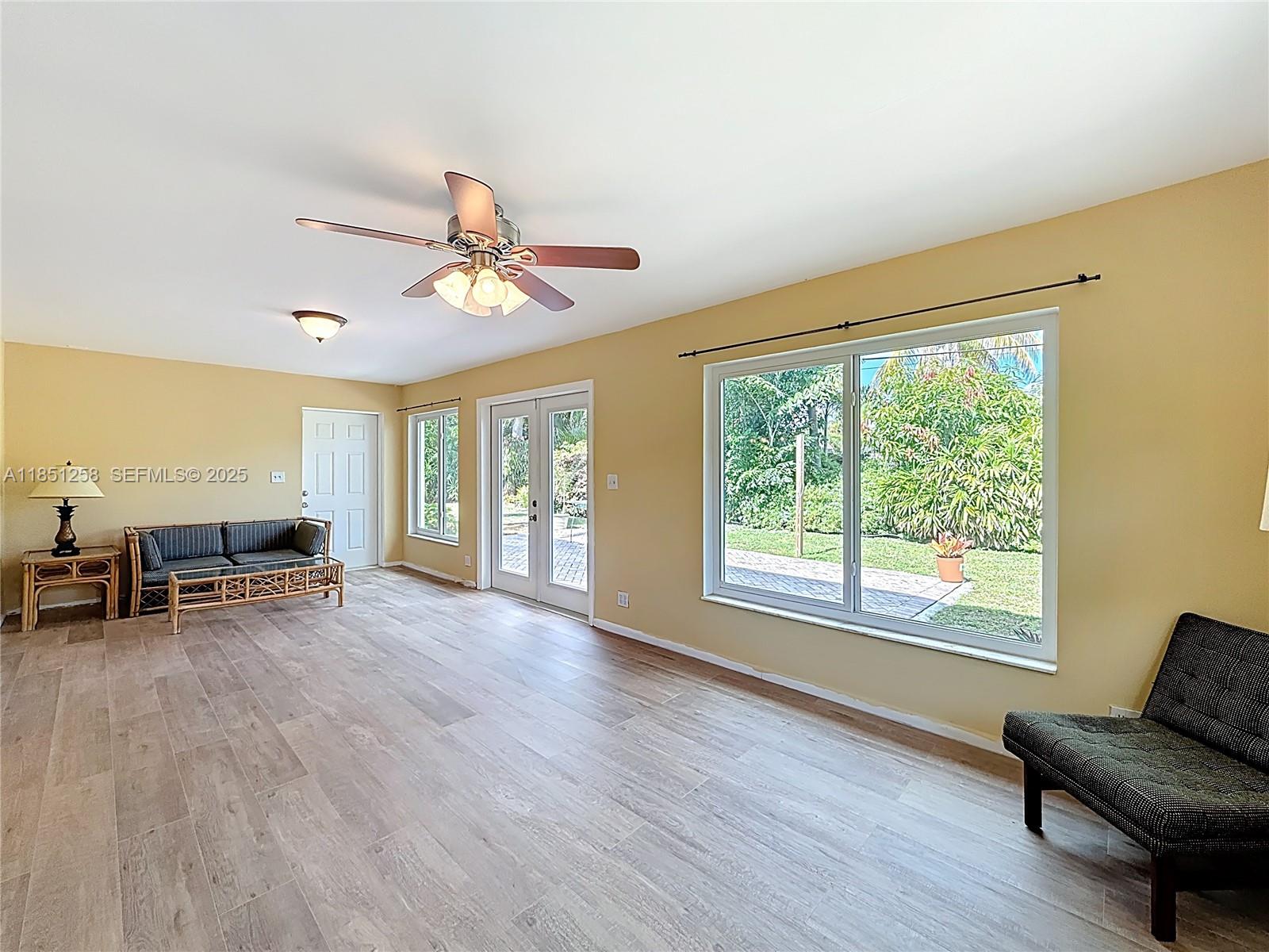 4911 Northeast 24th Avenue Lighthouse Point, FL 33064 - Photo 19 of 63 a living room with furniture and a large window