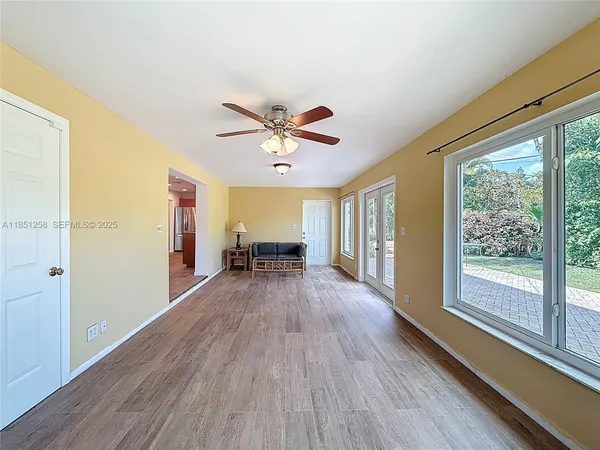 a dining room with table and chairs with wooden floor