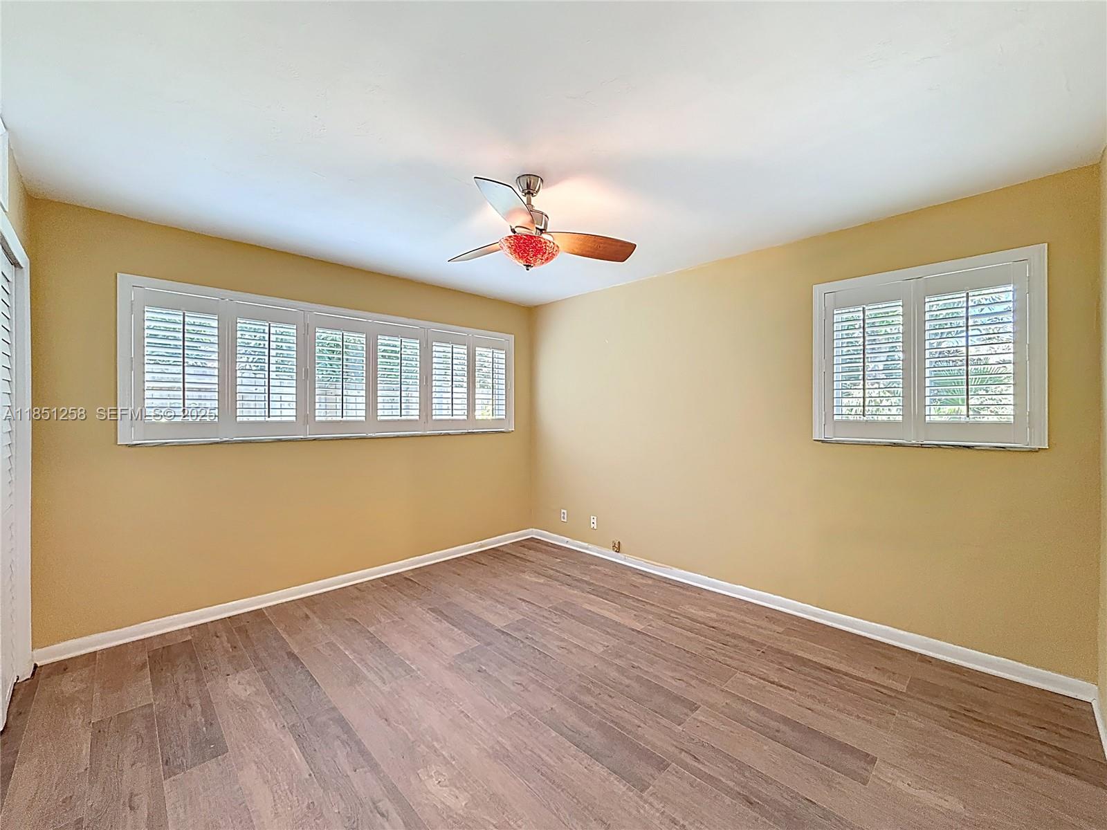 4911 Northeast 24th Avenue Lighthouse Point, FL 33064 - Photo 28 of 63 a view of an empty room with wooden floor and a window