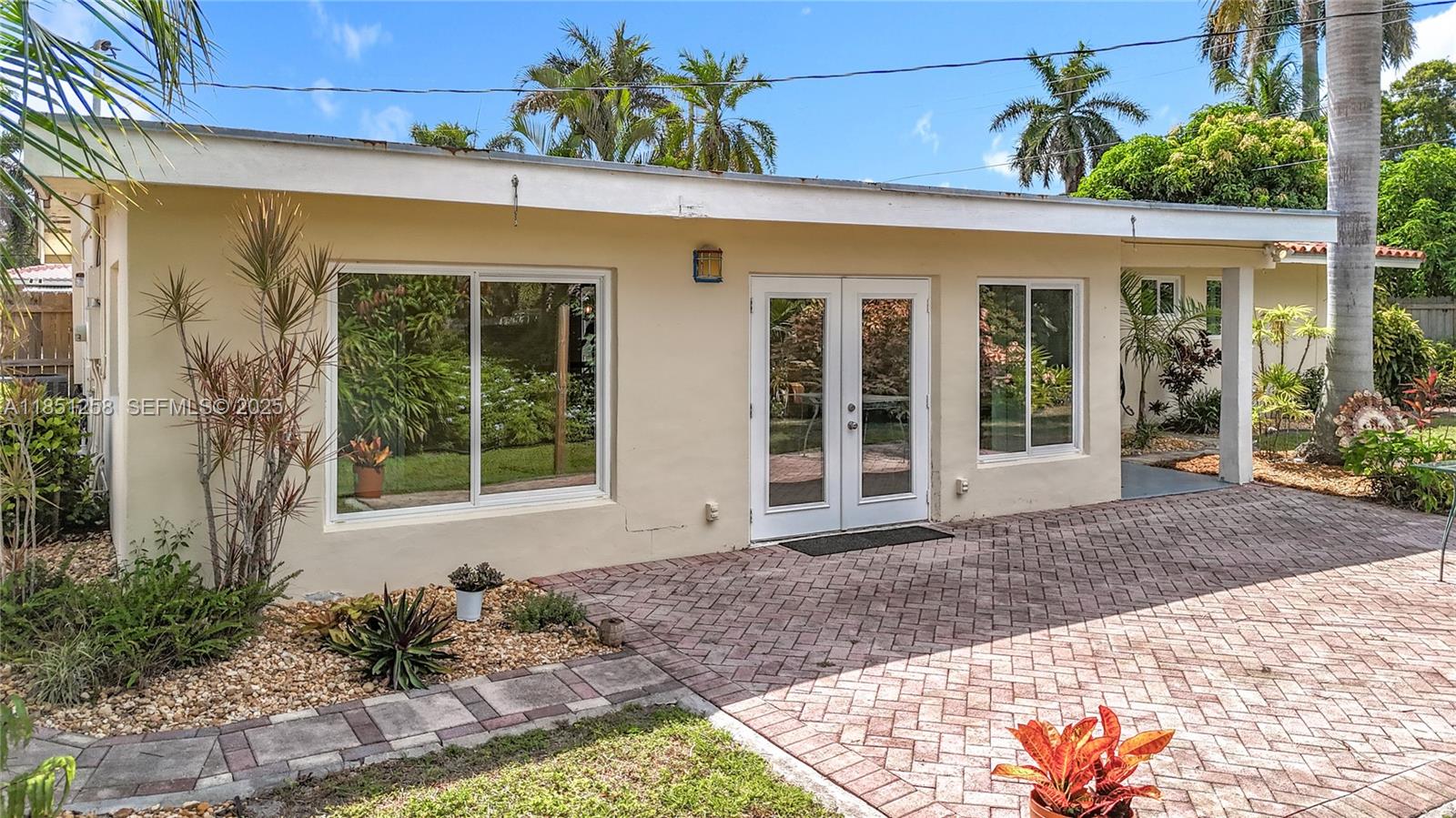 4911 Northeast 24th Avenue Lighthouse Point, FL 33064 - Photo 45 of 63 a front view of a house with a porch
