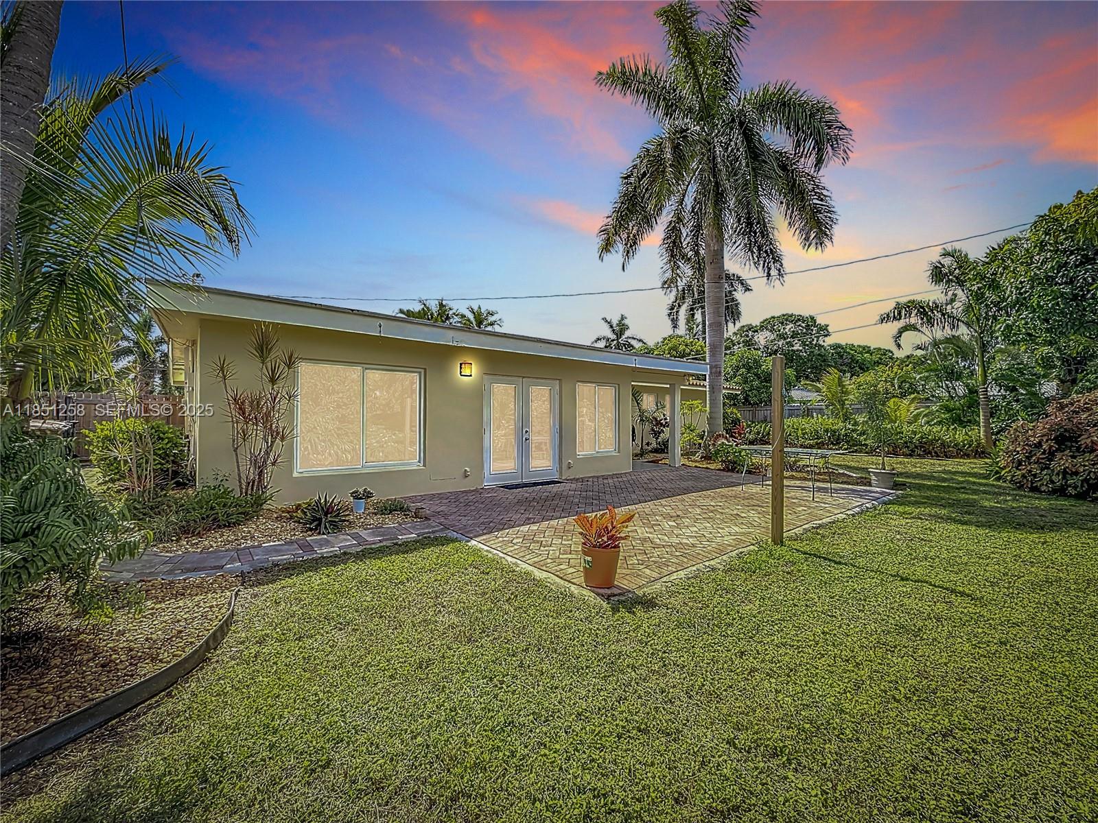 4911 Northeast 24th Avenue Lighthouse Point, FL 33064 - Photo 49 of 63 a house with a swimming pool in front of it