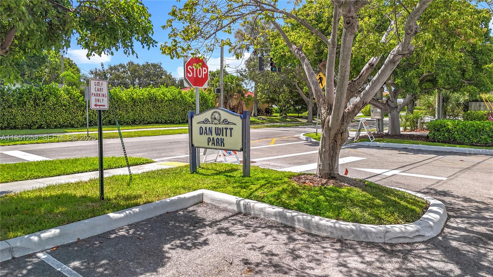 4911 Northeast 24th Avenue Lighthouse Point, FL 33064 - Photo 54 of 63 a sign board with a yard and large trees