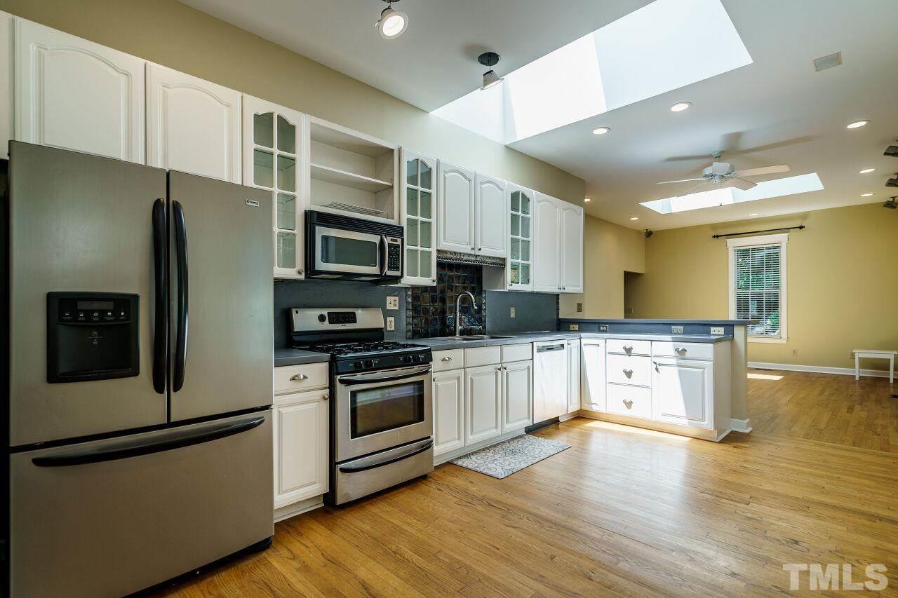 111 North Bloodworth Street Raleigh, NC 27601 - Photo 3 of 3 a kitchen with stainless steel appliances granite countertop a refrigerator a stove top oven a sink and dishwasher