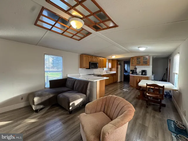 a kitchen with stainless steel appliances granite countertop wooden cabinets a stove top oven a sink and dishwasher