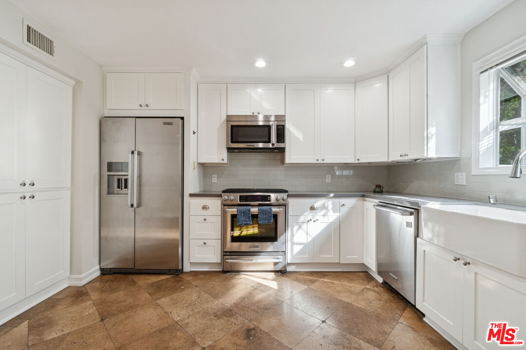 880 Hilldale Avenue, Unit 3 West Hollywood, CA 90069 - Photo 11 of 43 a kitchen with stainless steel appliances granite countertop a refrigerator and a stove top oven
