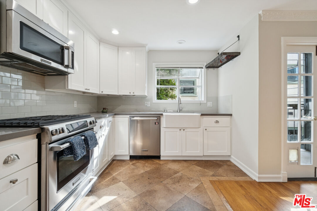 880 Hilldale Avenue, Unit 3 West Hollywood, CA 90069 - Photo 13 of 43 a kitchen with stainless steel appliances granite countertop a stove a sink and a microwave