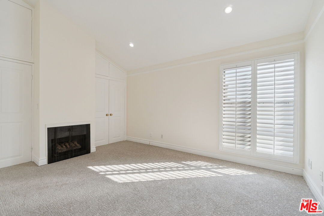 880 Hilldale Avenue, Unit 3 West Hollywood, CA 90069 - Photo 21 of 43 an empty room with a fireplace and window