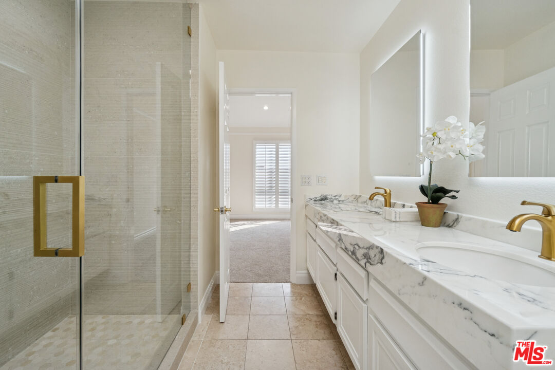 880 Hilldale Avenue, Unit 3 West Hollywood, CA 90069 - Photo 26 of 43 a spacious bathroom with a granite countertop sink a mirror and shower
