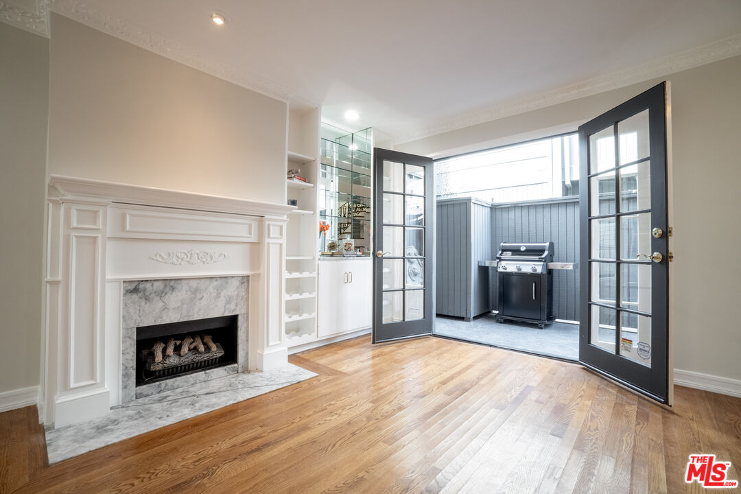 880 Hilldale Avenue, Unit 3 West Hollywood, CA 90069 - Photo 5 of 43 a view of a livingroom with a fireplace and cabinet