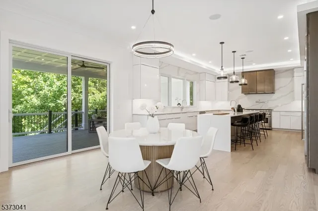 a kitchen with stainless steel appliances a stove a sink a refrigerator and a window