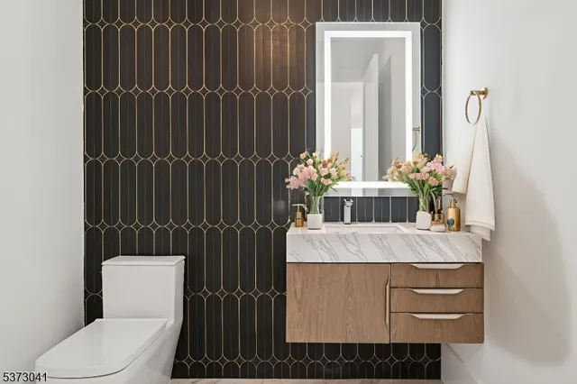 a dining room with wooden floor a chandelier a glass table and chairs
