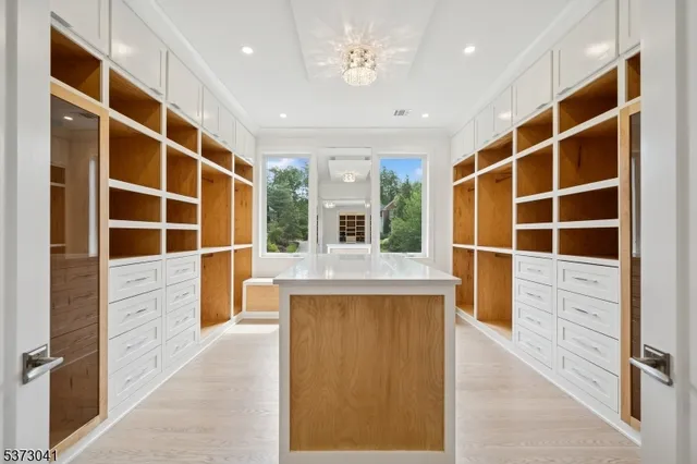 a spacious bedroom with a bed and wooden floor