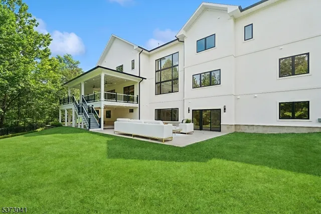 a front view of a house with a garden and yard